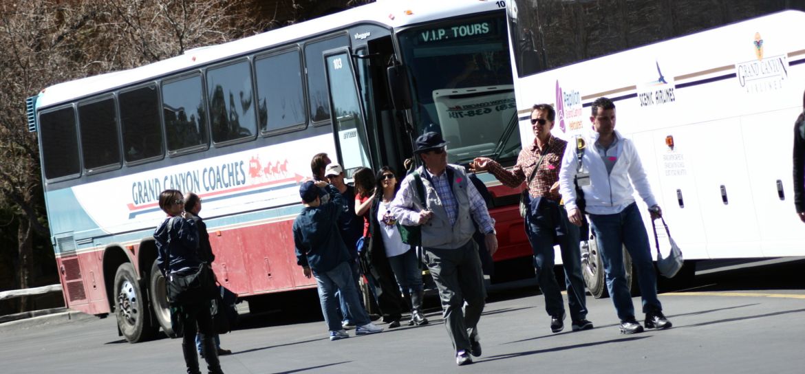 People boarding a bus for their grand canyon tour