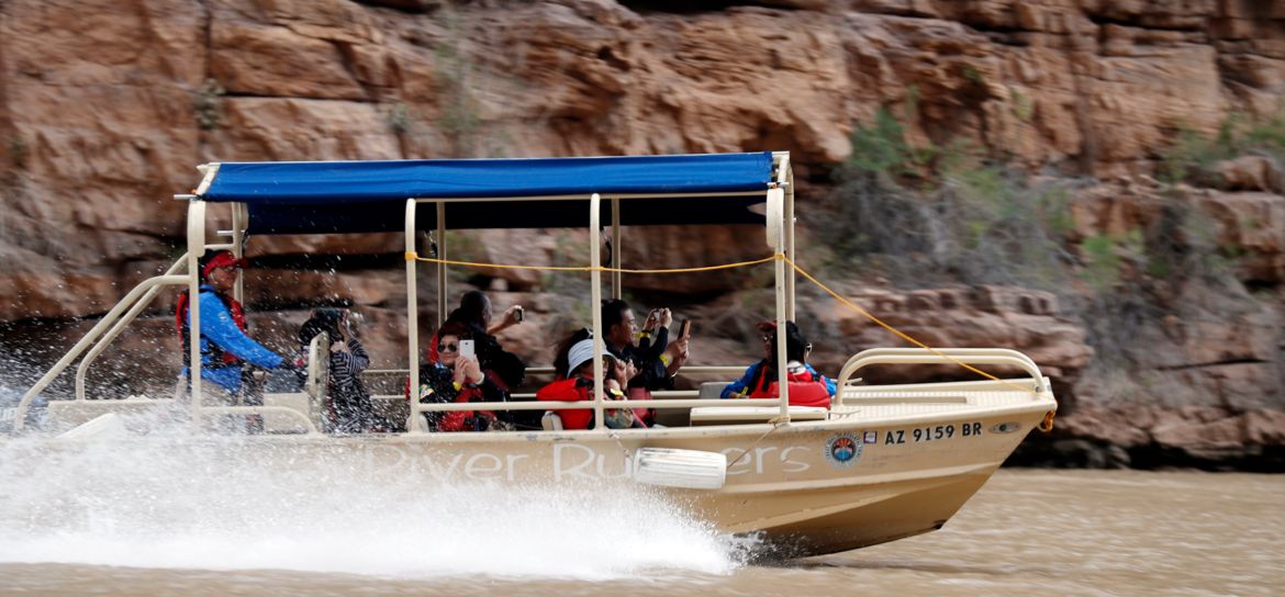 Skywalk Getaway with Helicopter and Boat Recommend inserting image of pontoon boat cruising along the Colorado River in this section.