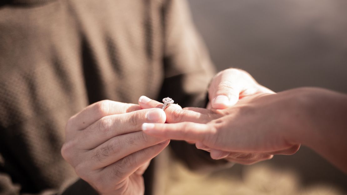 Proposal at Grand Canyon Man putting engagement ring on woman at Grand Canyon.
