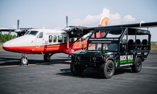 Fly by airplane and then explore by hummer Hummer and DHC-6 parked next to each other.