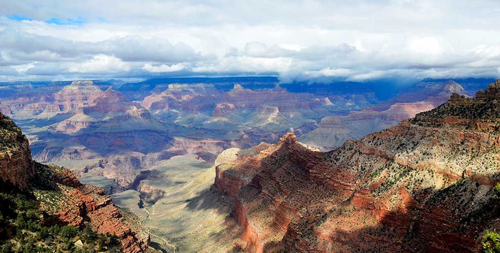 Experience a Helicopter View of Grand Canyon A landscape image of the Grand Canyon during a Papillon Grand Canyon Helicopter tour experience