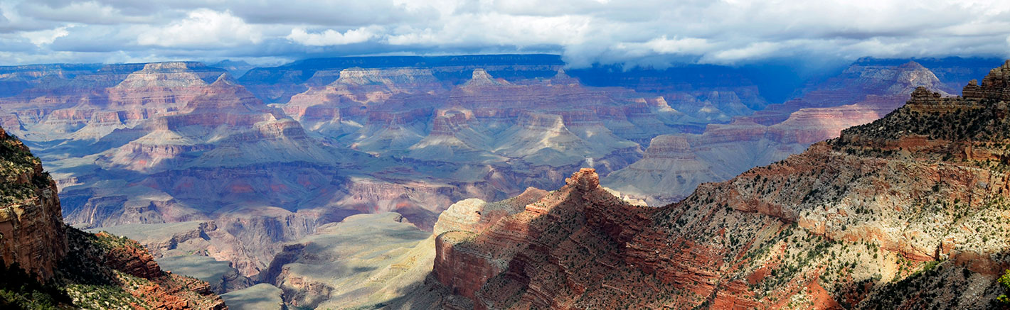 A panoramic image of the Grand Canyon and a cloudy sky.