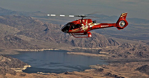 Golden Eagle Helicopter Tour to Grand Canyon West A Papillon helicopter flying over the Grand Canyon as passengers enjoy the discounted Golden Eagle helicopter tour