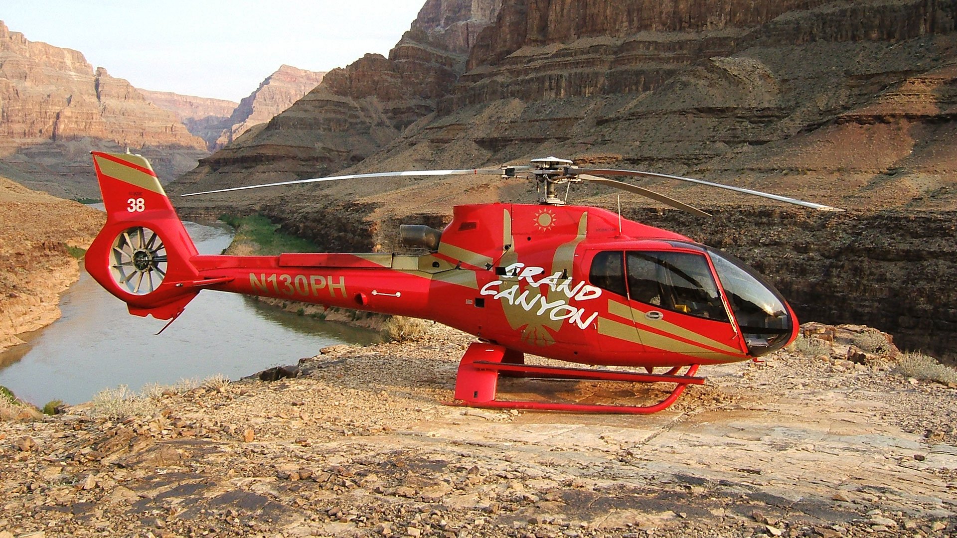EC-130 helicopter landed at the bottom of the Grand Canyon with the Colorado River in the background