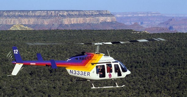 A Bell Helicopter soaring over Grand Canyon National Park